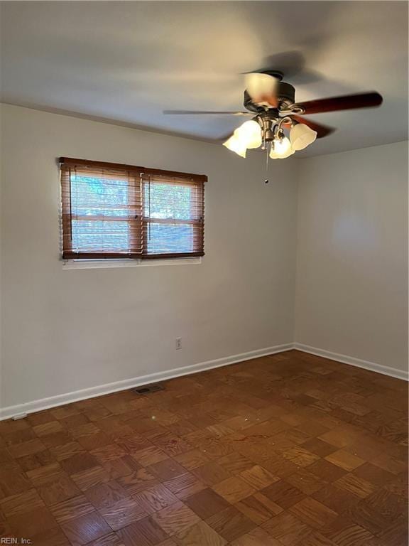 unfurnished room featuring baseboards and ceiling fan