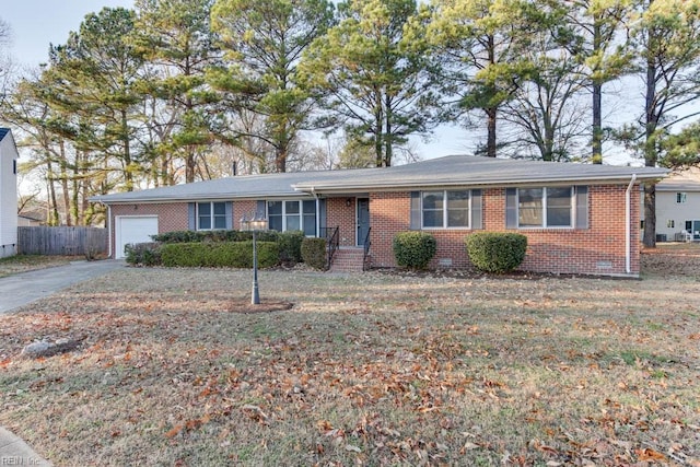 single story home with brick siding, an attached garage, concrete driveway, and fence