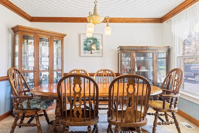 dining space with visible vents, baseboards, and ornamental molding