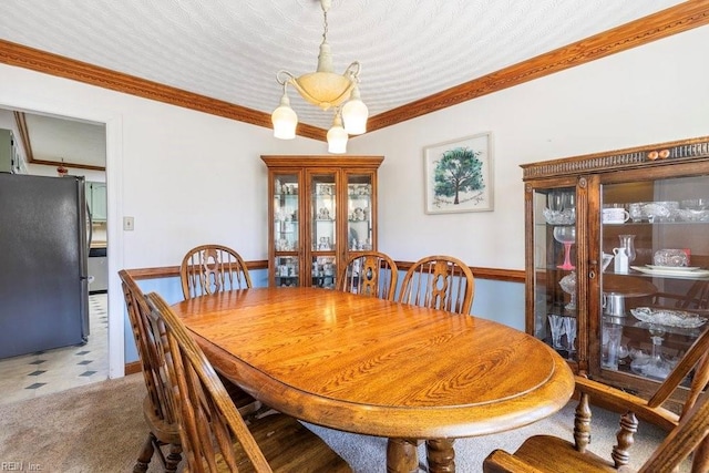 dining room with tile patterned floors and ornamental molding