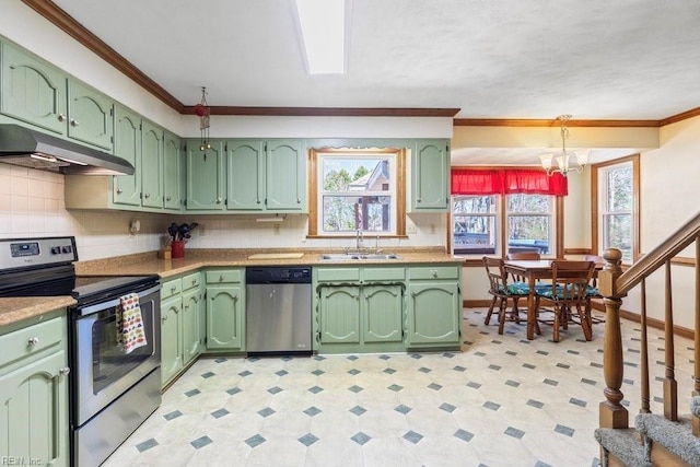 kitchen with under cabinet range hood, a sink, appliances with stainless steel finishes, and green cabinetry