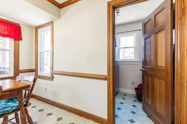 dining space featuring baseboards and light floors