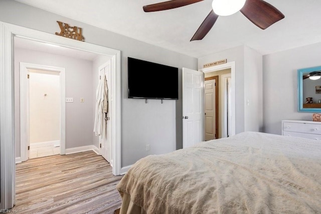 bedroom featuring a ceiling fan, baseboards, and light wood-type flooring