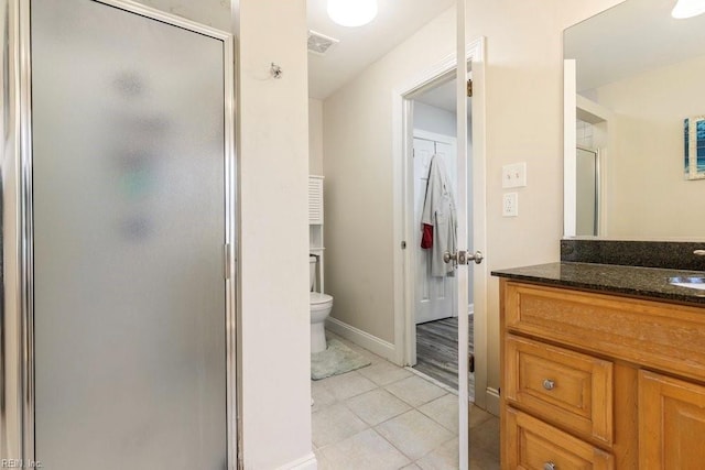 full bathroom with visible vents, toilet, a shower stall, tile patterned flooring, and vanity