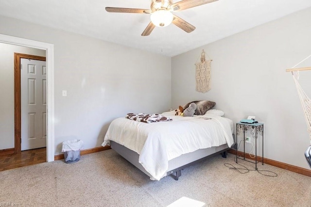 carpeted bedroom featuring baseboards and ceiling fan