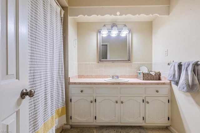 bathroom with curtained shower and vanity