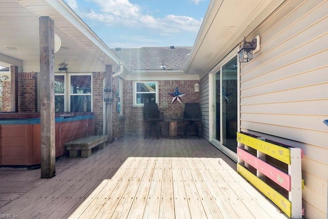 wooden terrace with a hot tub