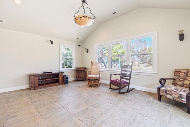 sitting room with visible vents, baseboards, and vaulted ceiling