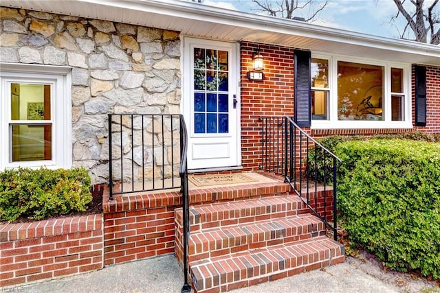 property entrance featuring stone siding