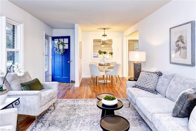 living room with baseboards and wood finished floors