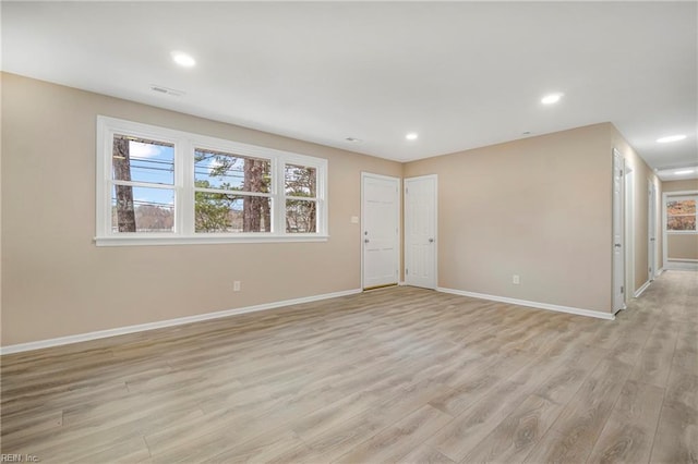 spare room featuring recessed lighting, light wood-style floors, visible vents, and baseboards