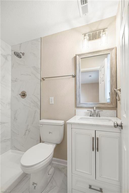 full bath featuring visible vents, toilet, tiled shower, marble finish floor, and vanity