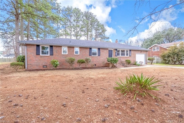 ranch-style home featuring driveway, a chimney, a garage, crawl space, and brick siding