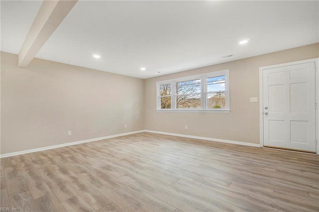 unfurnished room with recessed lighting, light wood-type flooring, baseboards, and beam ceiling