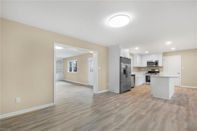 kitchen featuring light countertops, white cabinets, light wood-style floors, and appliances with stainless steel finishes