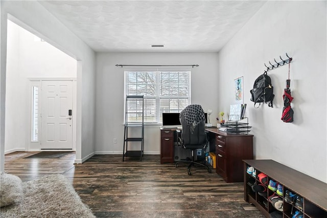 office with dark wood finished floors, visible vents, baseboards, and a textured ceiling