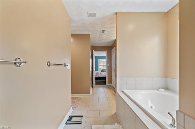 full bathroom with tile patterned flooring, visible vents, baseboards, a tub with jets, and ensuite bath