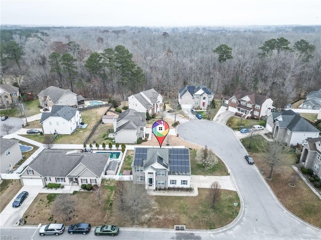 drone / aerial view featuring a forest view and a residential view