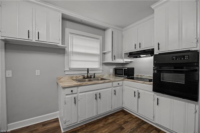 kitchen with under cabinet range hood, dark wood-style floors, white cabinets, black appliances, and a sink