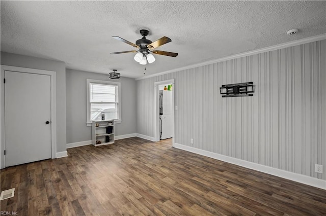 unfurnished living room featuring a ceiling fan, wood finished floors, baseboards, and a textured ceiling