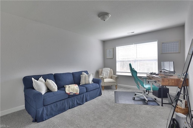 office space featuring carpet flooring, visible vents, and baseboards