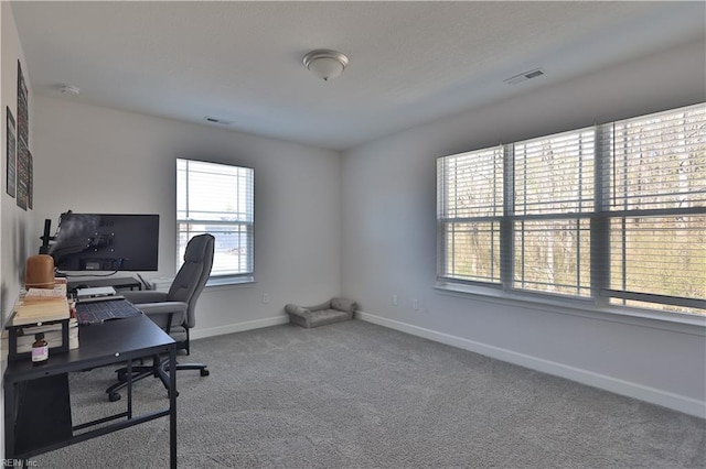 home office with visible vents, baseboards, and carpet flooring