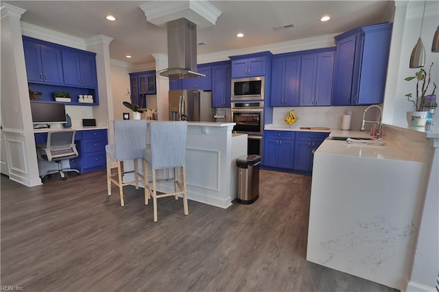 kitchen featuring blue cabinets, stainless steel appliances, island range hood, and a sink