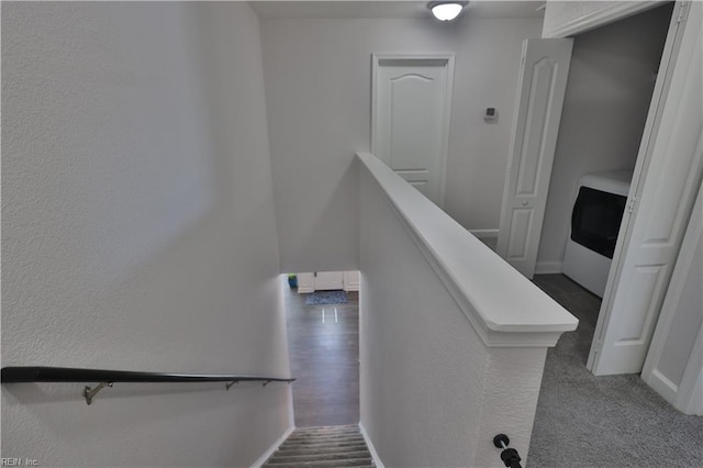 stairs featuring washer / dryer and baseboards