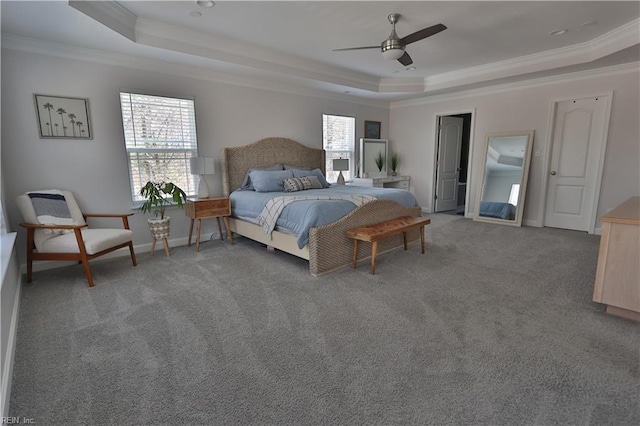 bedroom with a raised ceiling, crown molding, light colored carpet, and baseboards