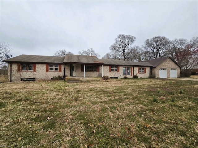 ranch-style house with a front yard, an attached garage, and covered porch