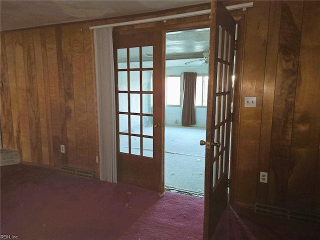 interior space with wooden walls and visible vents