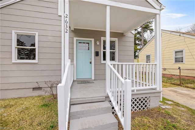 entrance to property with fence and crawl space