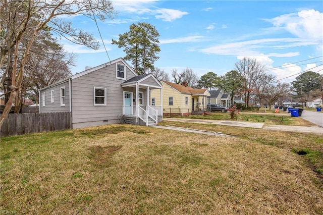 bungalow-style home featuring crawl space, a front lawn, and fence