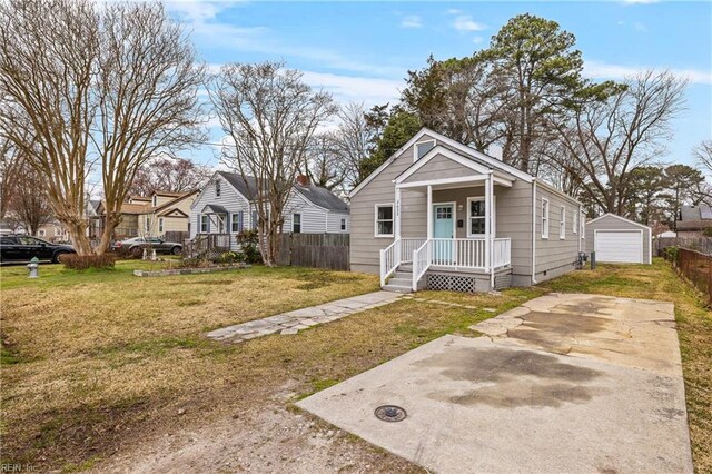 view of front of house with a front lawn, fence, crawl space, a porch, and an outbuilding