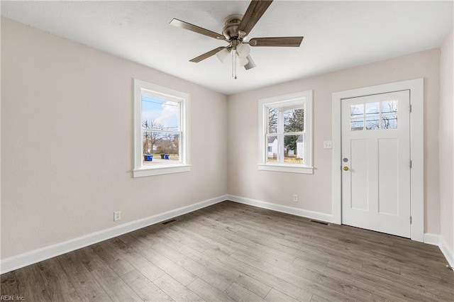 entryway with a wealth of natural light, baseboards, wood finished floors, and ceiling fan