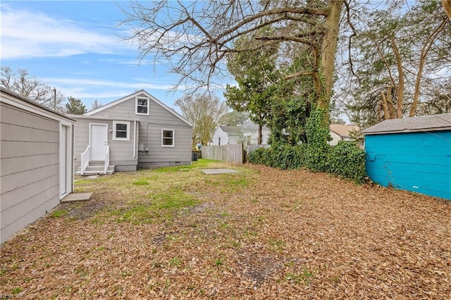 view of yard with fence and entry steps