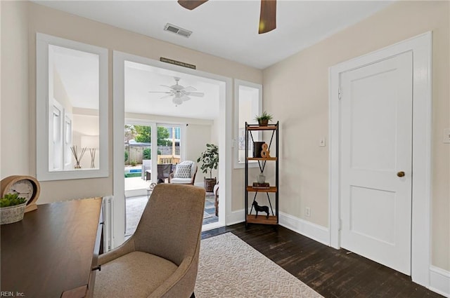 office with visible vents, baseboards, dark wood-style flooring, and a ceiling fan