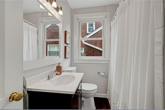 full bath with baseboards, toilet, and vanity