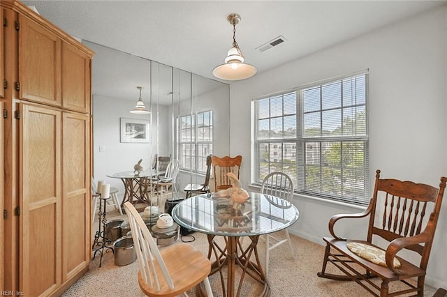 dining space featuring visible vents and baseboards