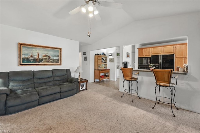 living area featuring ceiling fan, lofted ceiling, and light carpet