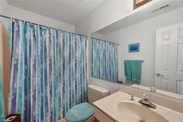 bathroom with vanity, curtained shower, toilet, and visible vents