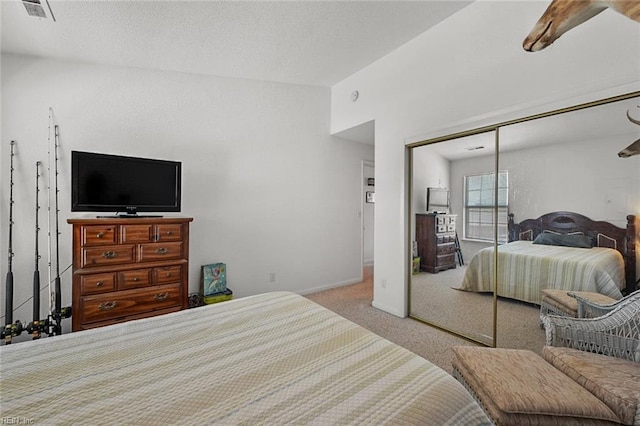 bedroom with visible vents, baseboards, carpet flooring, a closet, and a textured ceiling