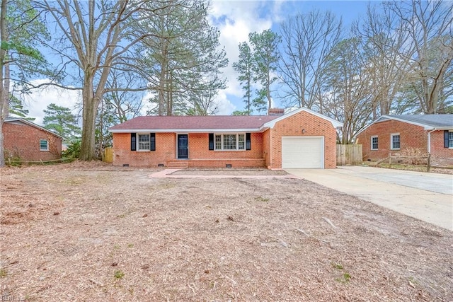 single story home with concrete driveway, an attached garage, crawl space, brick siding, and a chimney