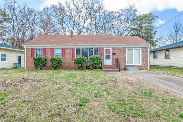 ranch-style home featuring entry steps, a front lawn, and brick siding