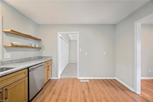 kitchen featuring baseboards, light stone countertops, stainless steel dishwasher, light wood-style floors, and open shelves