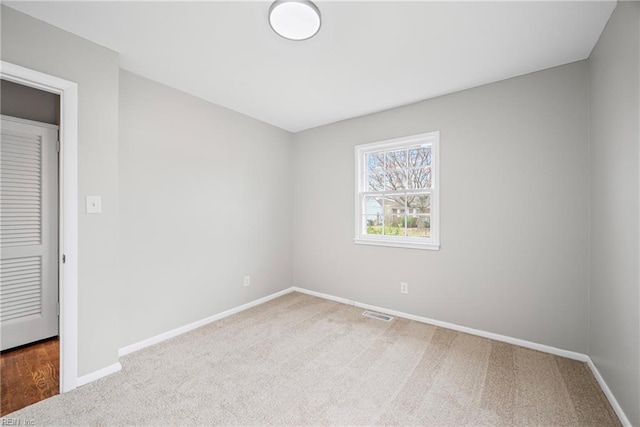 unfurnished room featuring visible vents, baseboards, and carpet floors