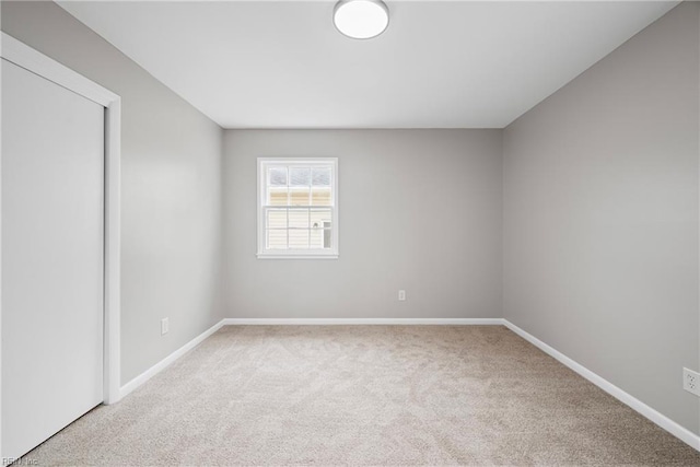 empty room with carpet flooring and baseboards