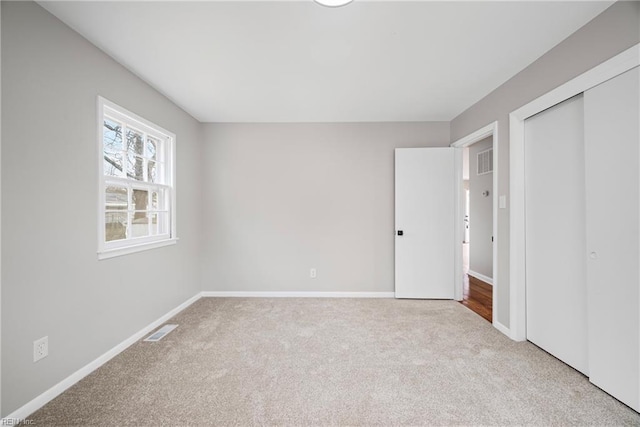 unfurnished bedroom featuring visible vents, baseboards, and carpet flooring