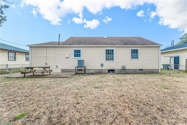 rear view of property with a patio, a yard, and fence