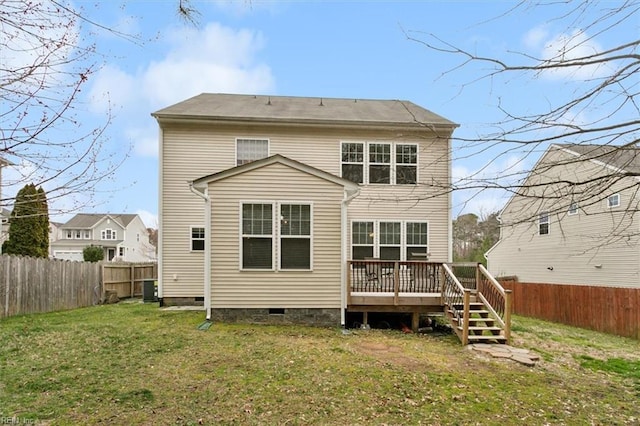 rear view of property with crawl space, a wooden deck, a fenced backyard, and a yard